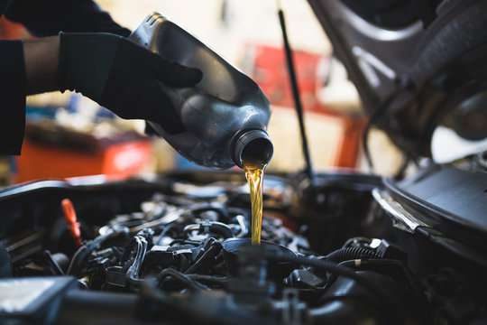 Engine oil being poured during a service at Linking Automobile Ltd
